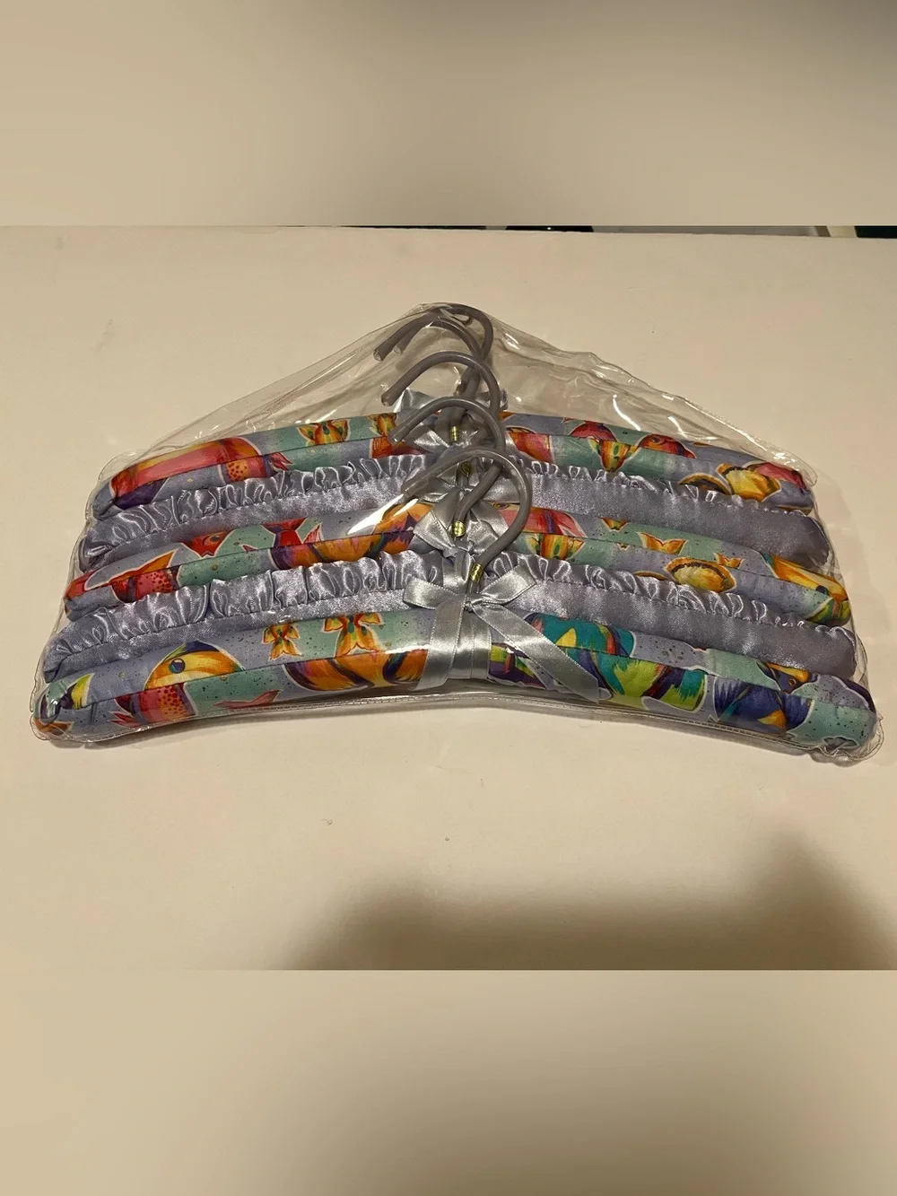 NWOT LOT OF COLORFUL PADDED FISH HANGERS.
